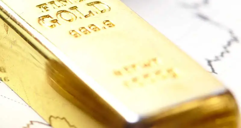 Goldbarren und Kursgrafik Goldpreis