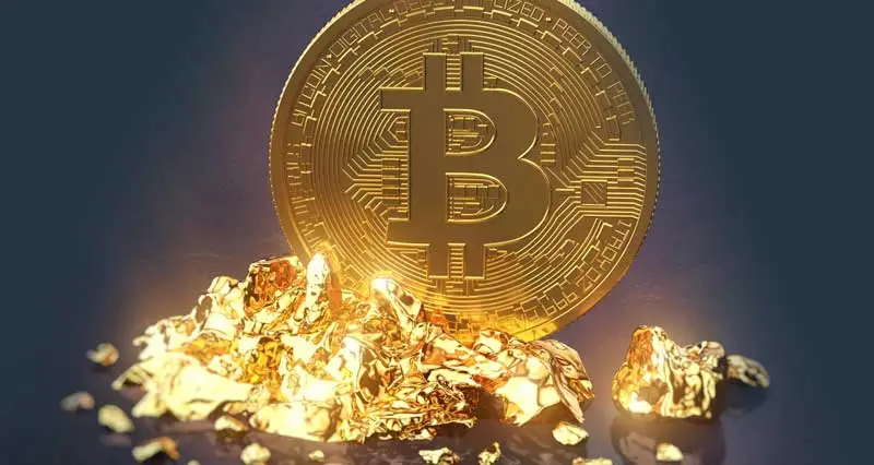 Gold Nuggets und eine Bitcoin Münze